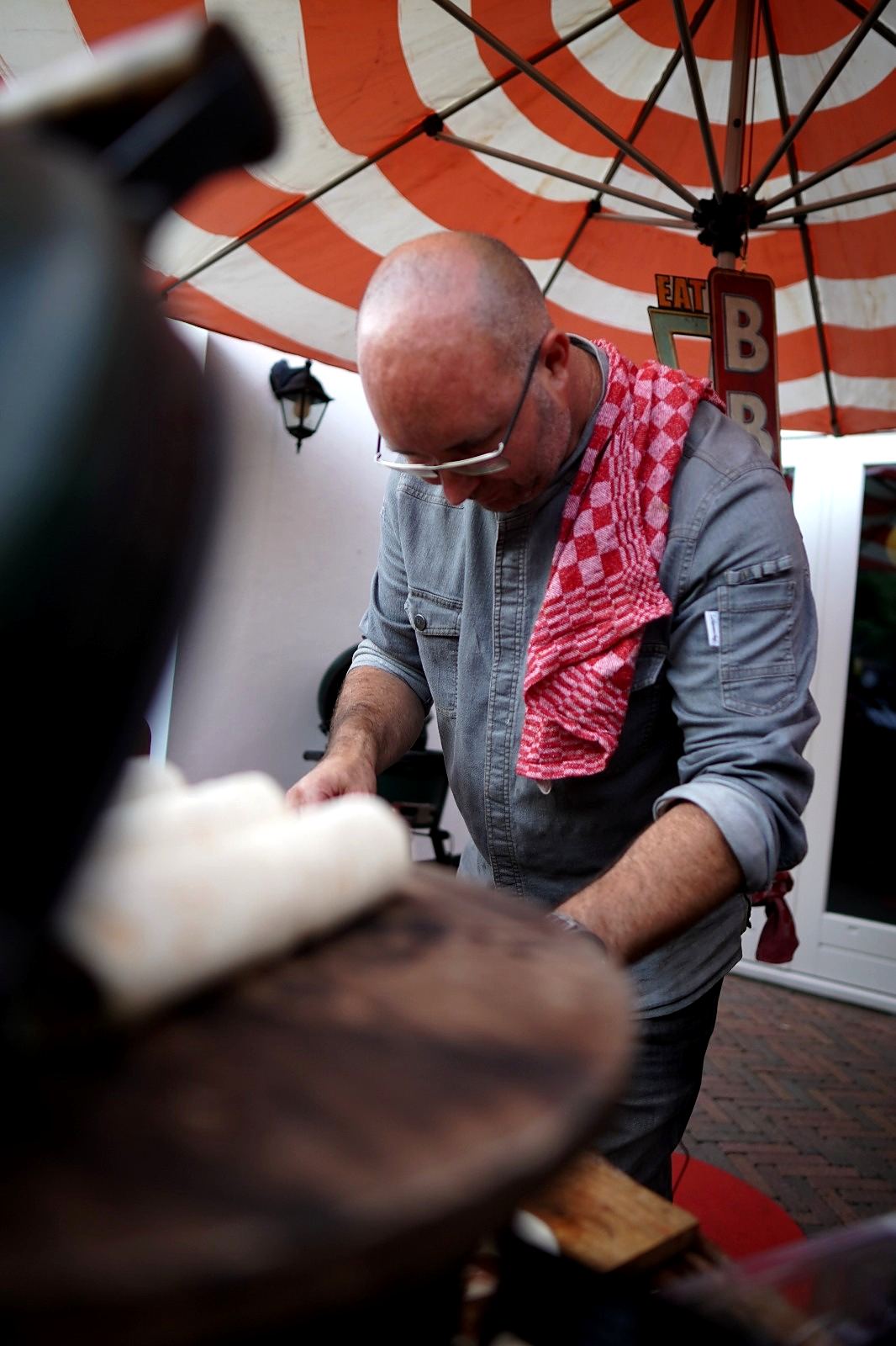Michael aan het werk onder een rood-witte parasol